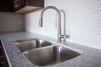 A kitchen sink with a faucet